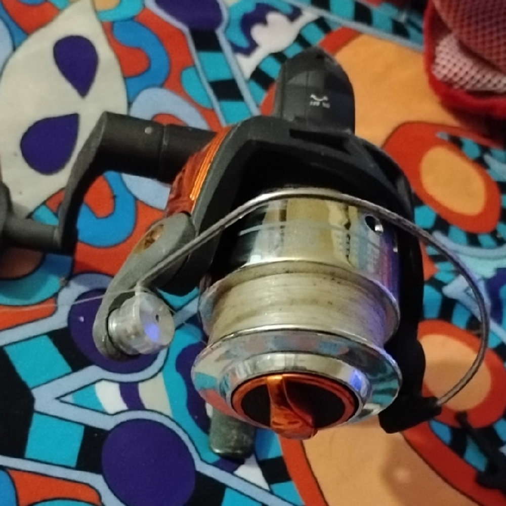 Vibrant Orange and Silver South Bend Fishing Reel